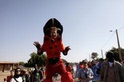 Activists on stilts dressed as bolt cutters